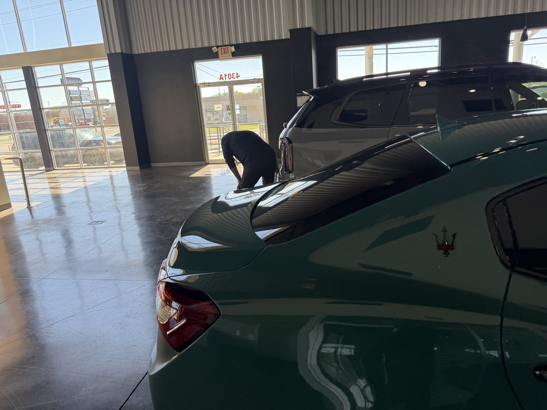 Green sedan rear side